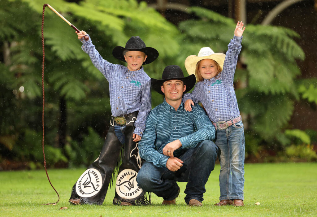 Byron Kirk (8 yrs) and his sister Willow (6 yrs) from Mt Isa and reigning open Bull Riding Champion Troy Wilkinson_at the launch of ROAD TO RODEO Longreach_photo Pete Wallis