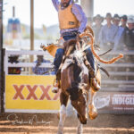 MI211913-Gangalida man Peter Jupiter in the 2nd Divi Saddle Bronc ride on the first day of the 2022 Mount Isa Mines Rodeo