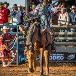 MI212119-Pitta Pitta man and Territorian cowboy Jason Craigie wins the Bareback contest with a 67pt ride at the inaugural Mount Isa Mines Indigenous Rodeo